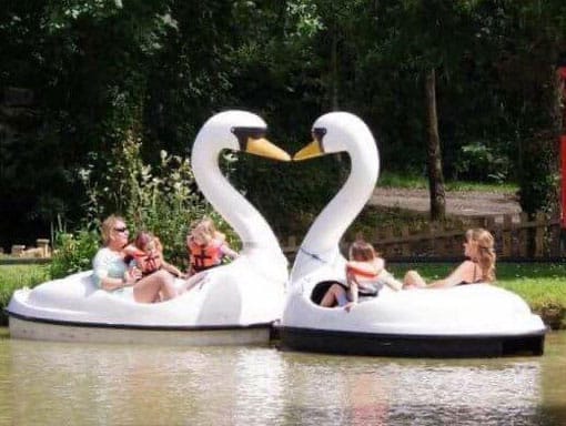 A family enjoying the Swan Lake Pedalos