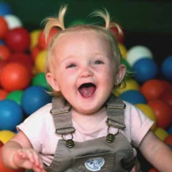 Happy toddler in the ball pit