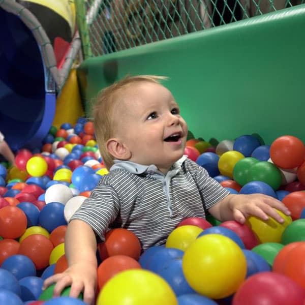 Toddler having fun in the ball pit