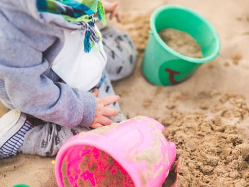 Toddler having fun in our sandpit