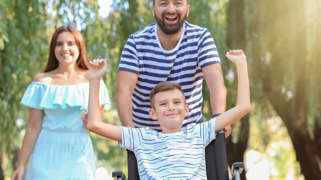 A child in a wheelchair enjoying a day out